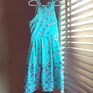 A blue dress that has flowers on it